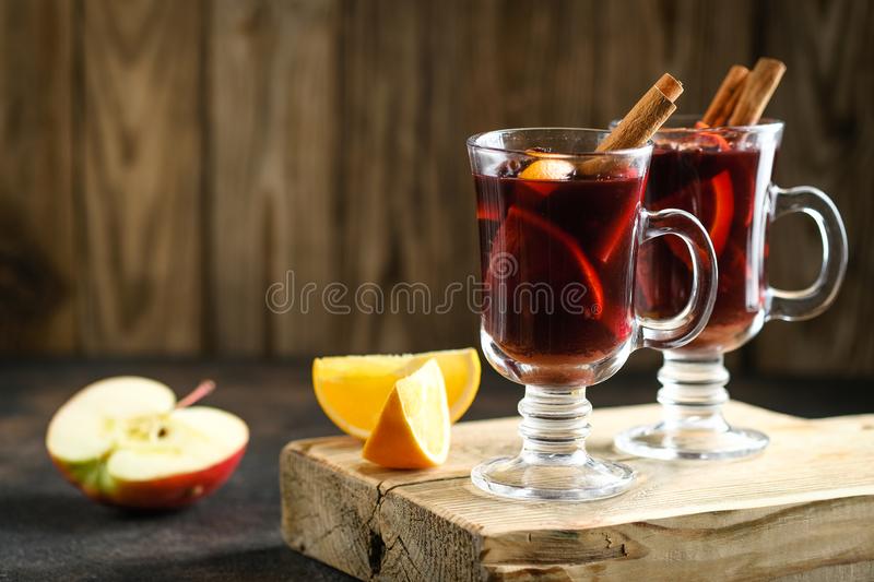 mulled-wine-glass-glasses-apples-orange-cinnamon-star-anise-hot-christmas-drink-dark-background-spruce-branch-163961275.jpg